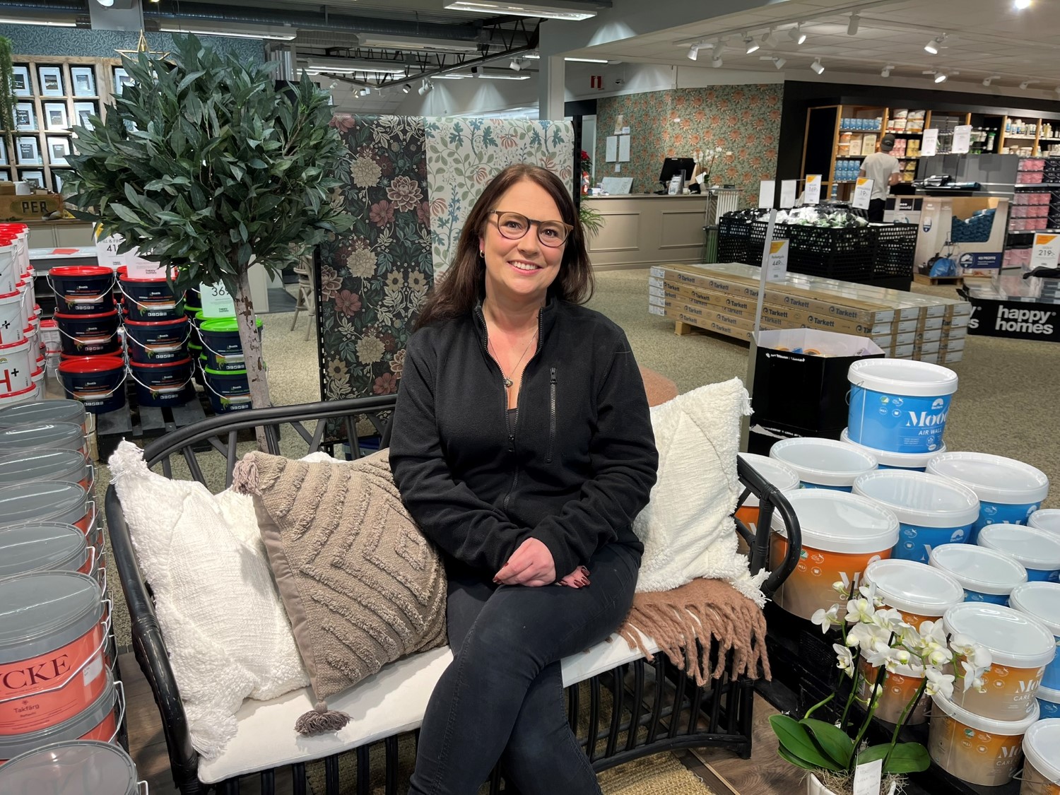 Ägaren Angelica sitter i en soffa mitt i butiken.